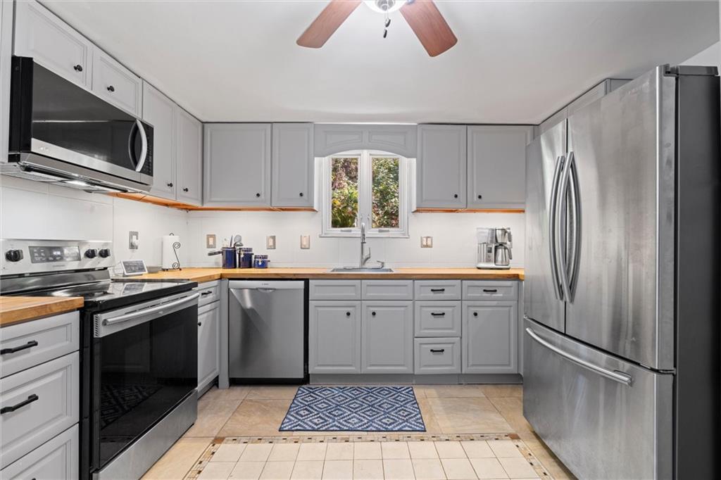 520 Knoll Street Pittsburgh, PA 15212 - Photo 15 of 47 a kitchen with granite countertop stainless steel appliances a stove sink and microwave