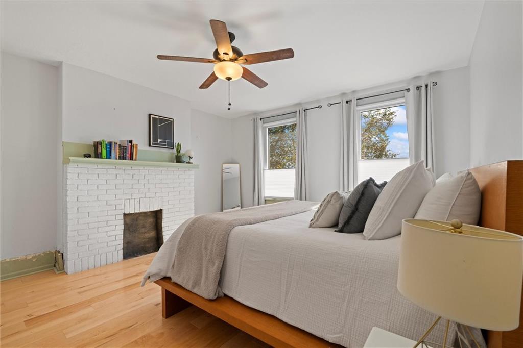 520 Knoll Street Pittsburgh, PA 15212 - Photo 17 of 47 a bedroom with a large bed and a fireplace