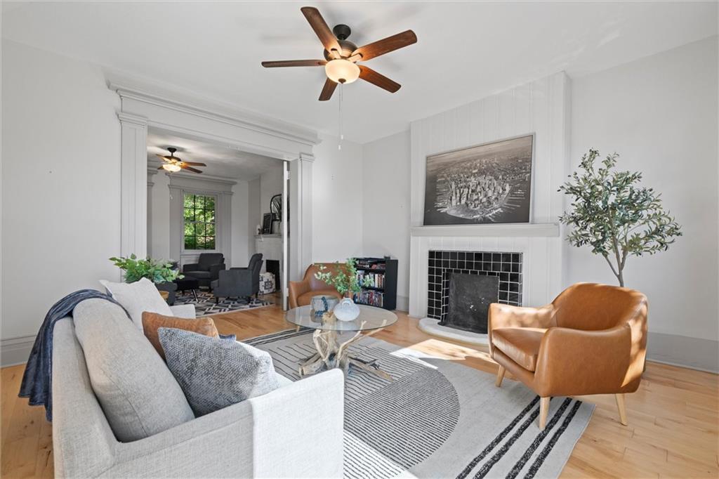 520 Knoll Street Pittsburgh, PA 15212 - Photo 3 of 47 a living room with furniture a chandelier and a fireplace