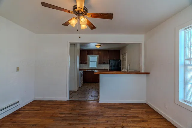 wooden floor in an empty room with a window