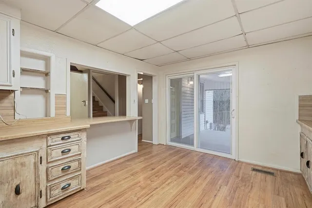 a view of cabinets a wooden floor and a window