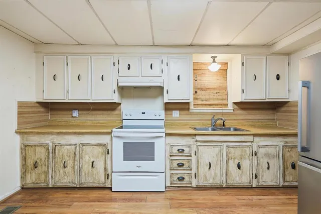 a kitchen with appliances cabinets and a sink