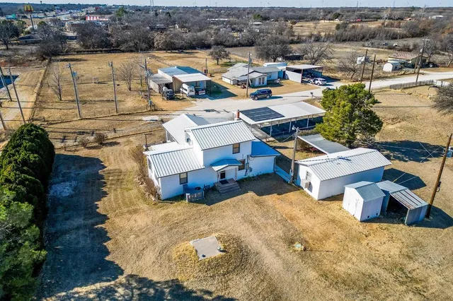 an aerial view of a house with outdoor space