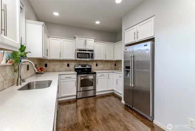 a kitchen with a refrigerator sink and microwave