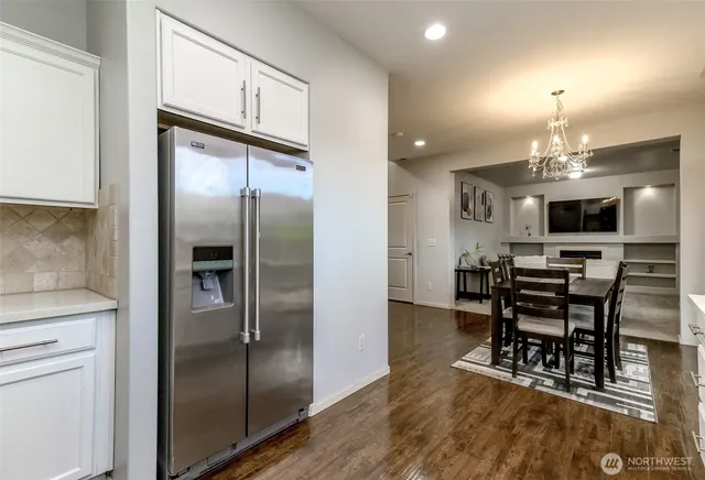 a kitchen with kitchen island a counter top space appliances and cabinets