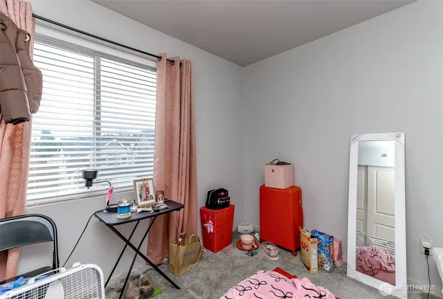 a bedroom with furniture and a window