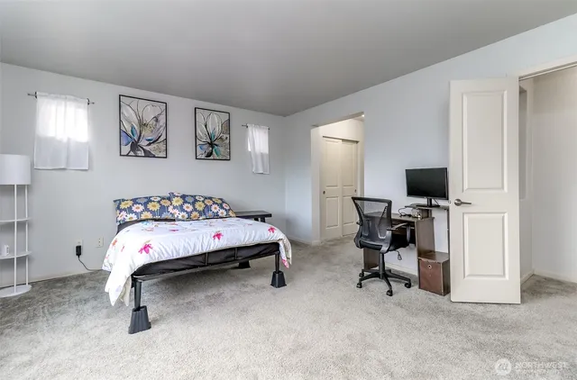 a bathroom with a tub a sink and a mirror