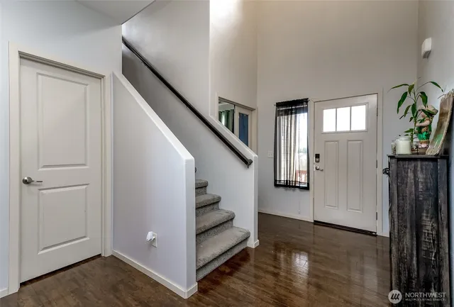 a view of entryway and hall with wooden floor