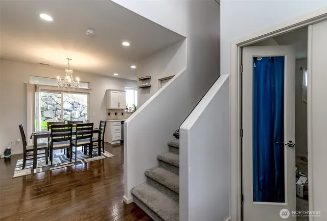 an entryway with dining room and wooden floor