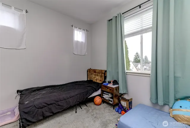 a bedroom with bed and a window