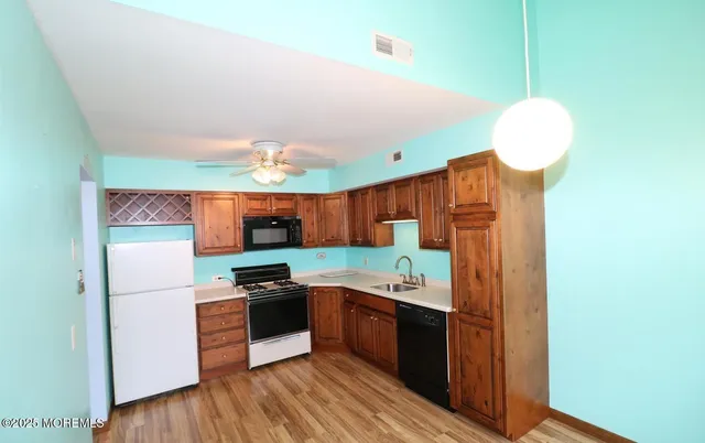 an empty room with wooden floor and cabinet
