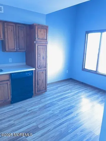 a white toilet sitting next to a white cabinet