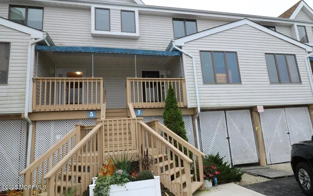 a view of a house with wooden deck
