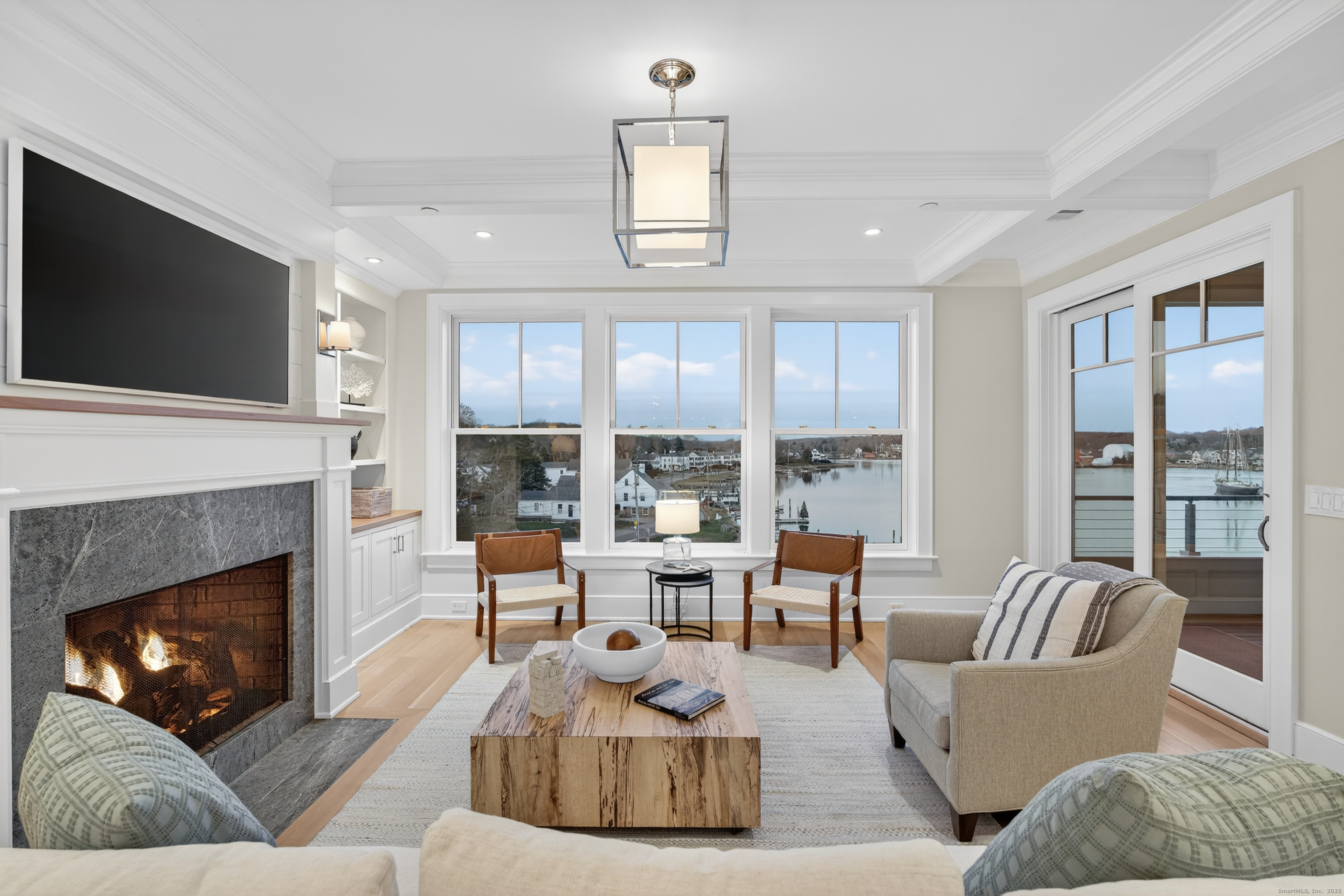 22 West Main Street, Unit 11 Groton, CT 06355 - Photo 19 of 40 a living room with furniture fireplace and flat screen tv
