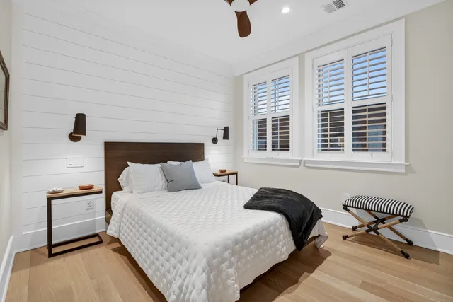 a bedroom with a bed and a painting on the wall