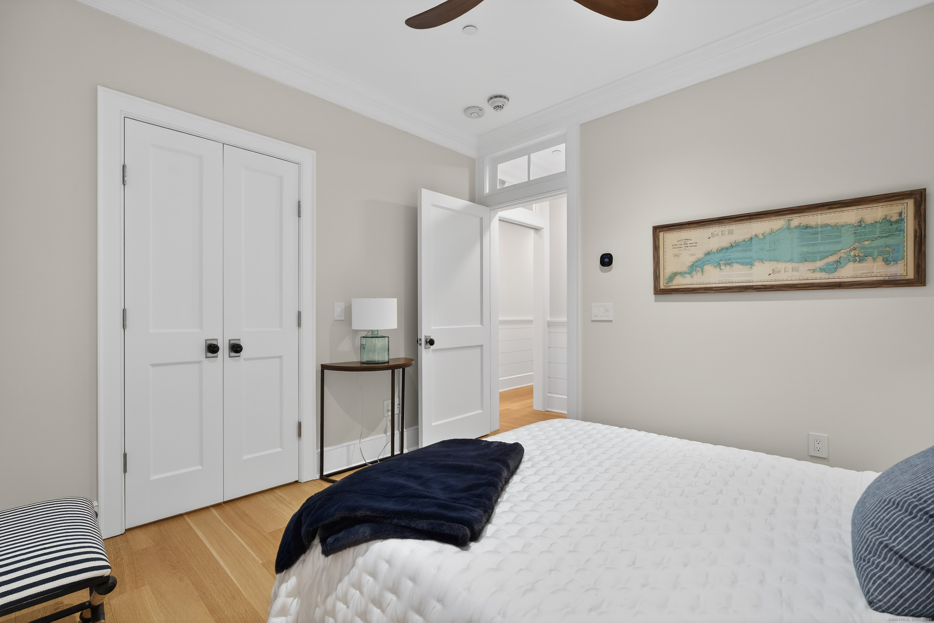 22 West Main Street, Unit 11 Groton, CT 06355 - Photo 32 of 40 a bedroom with a bed and a painting on the wall