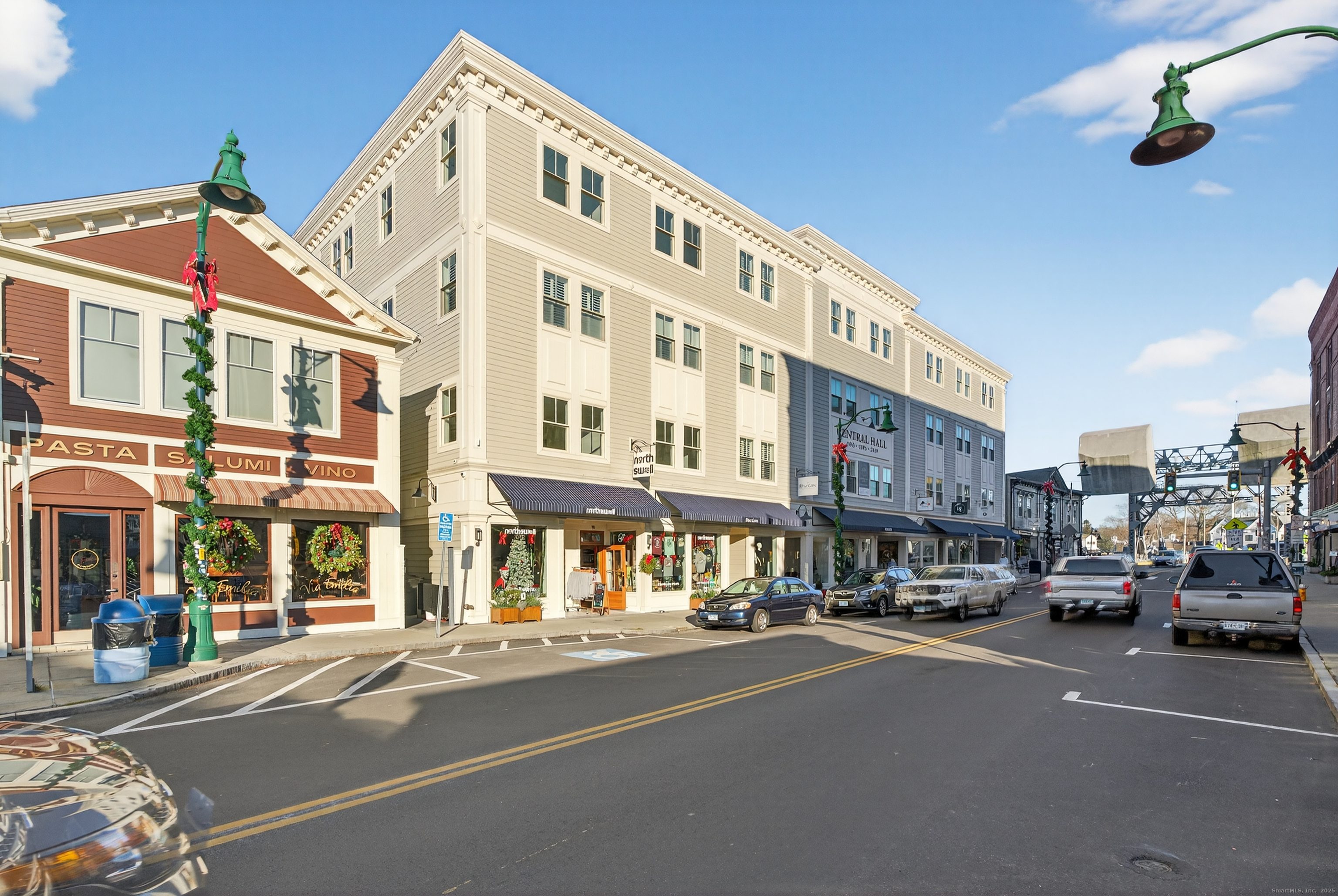 22 West Main Street, Unit 11 Groton, CT 06355 - Photo 33 of 40 a city street with tall buildings and cars parked on the street