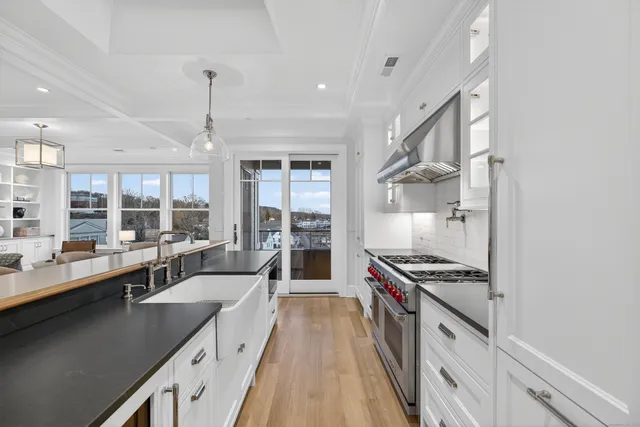 a large kitchen with stainless steel appliances a lot of counter space and a window