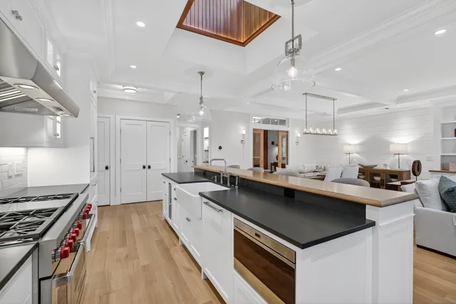 a kitchen with a sink a stove top oven and cabinets