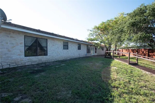 a view of backyard of house with green space