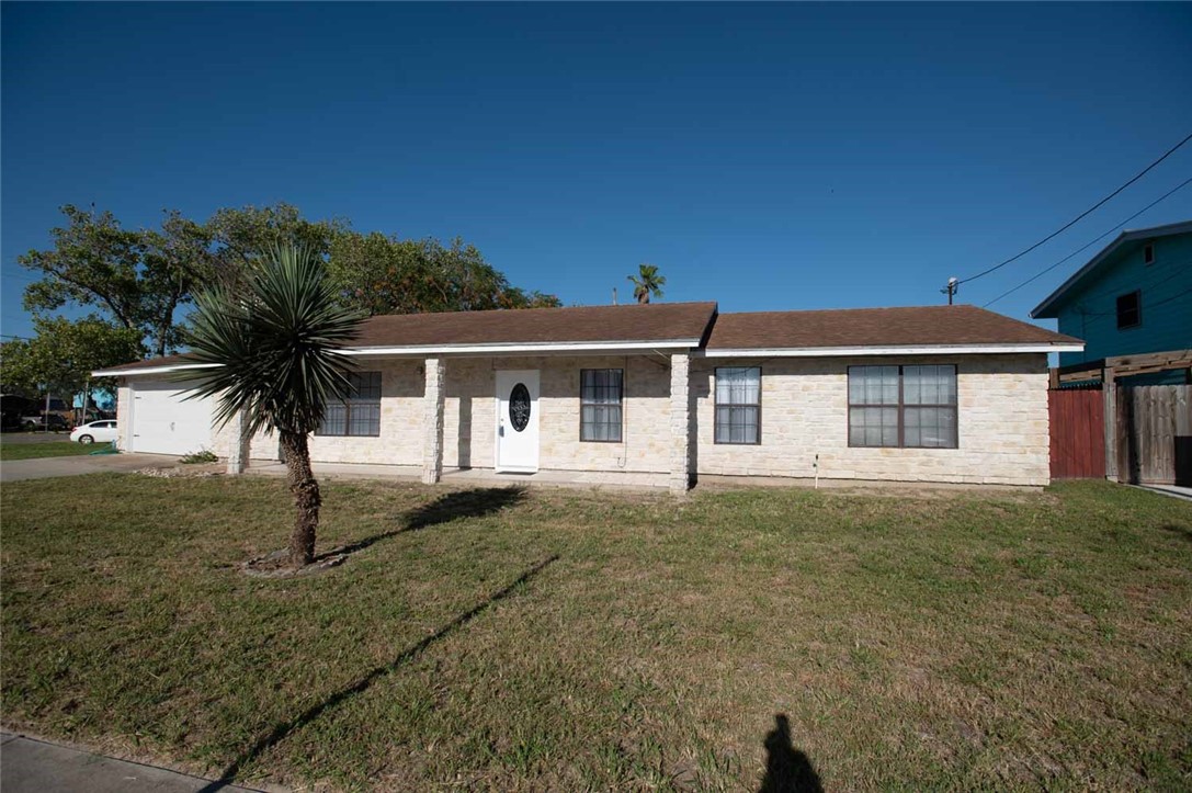 3442 Laguna Shores Road Corpus Christi, TX 78418 - Photo 14 of 15 a front view of a house with a garden