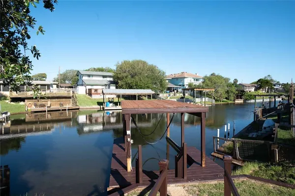 a view of a lake with a table and chairs