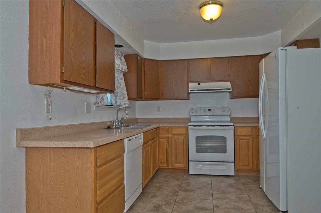 3442 Laguna Shores Road Corpus Christi, TX 78418 - Photo 8 of 15 a kitchen with stainless steel appliances granite countertop a sink stove and microwave