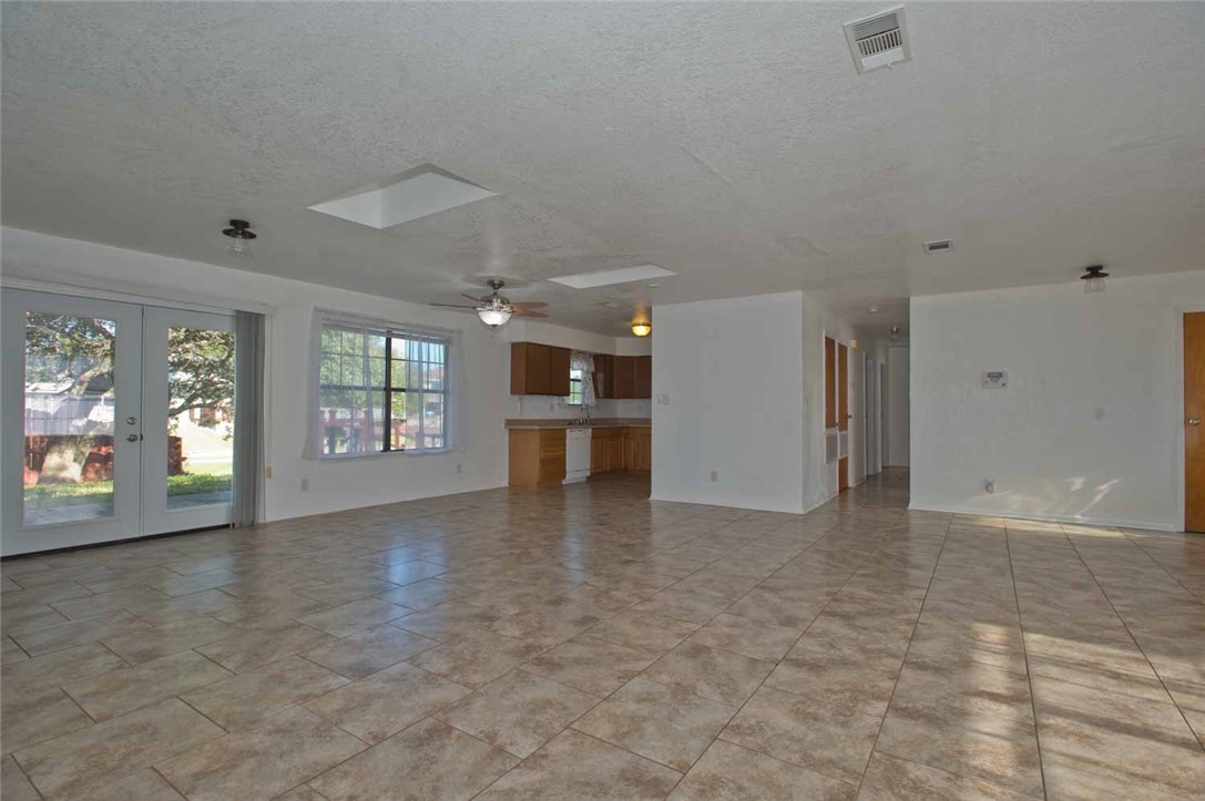 3442 Laguna Shores Road Corpus Christi, TX 78418 - Photo 10 of 15 wooden floor in an empty room with a window