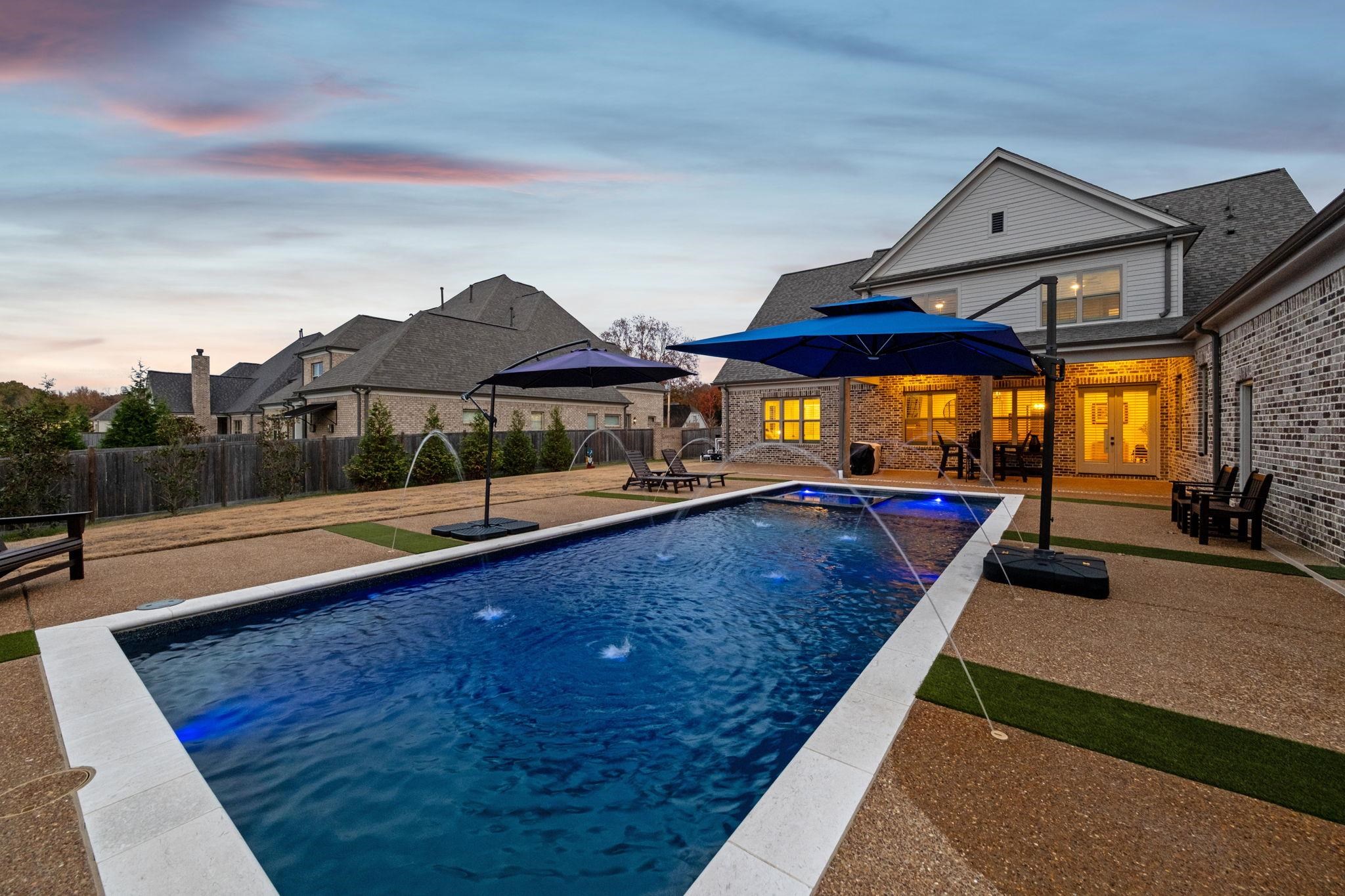 a view of swimming pool with chairs in patio