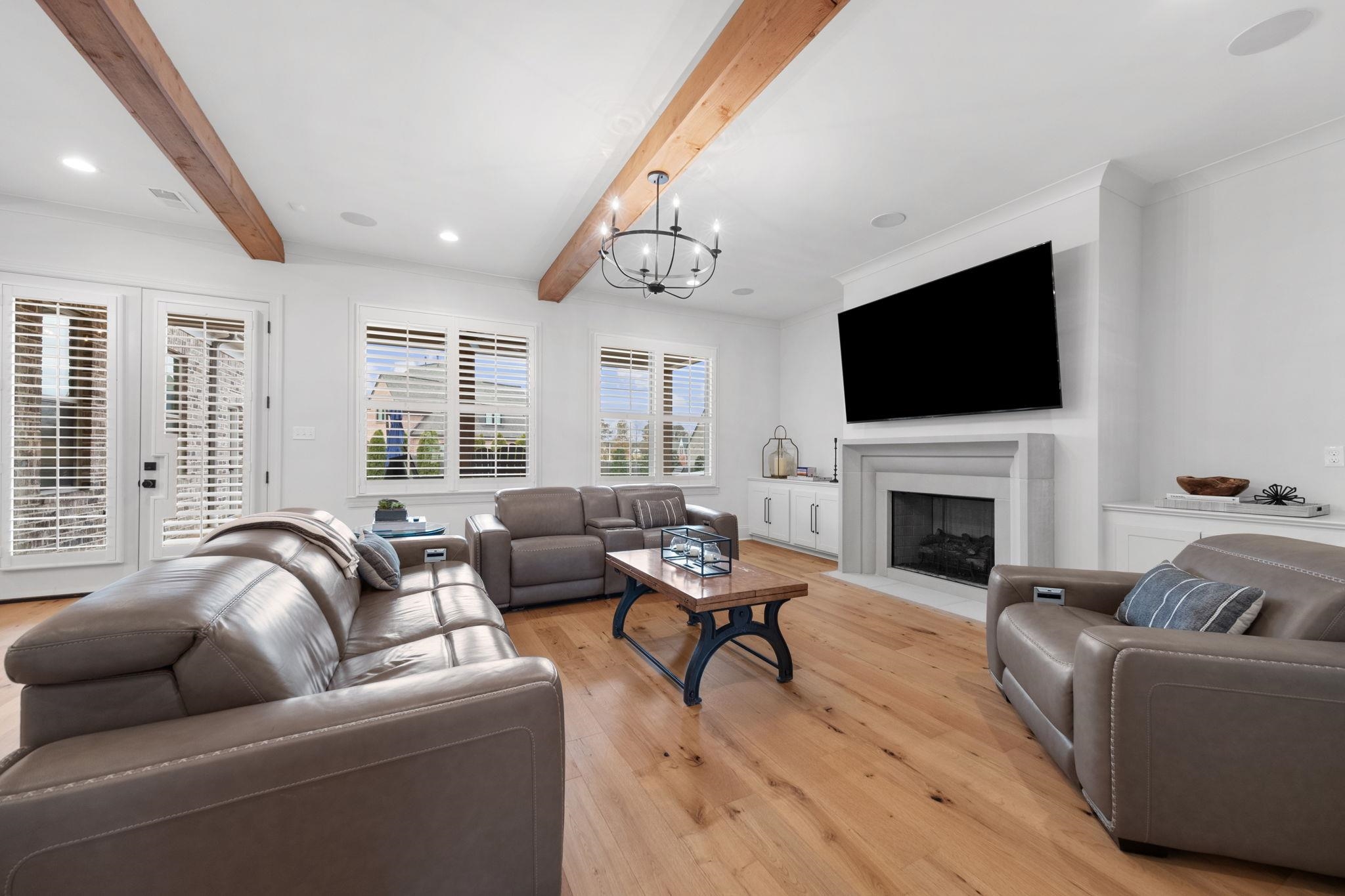 3361 Bailey Station Road Collierville, TN 38017 - Photo 11 of 40 a living room with furniture a fireplace and a flat screen tv