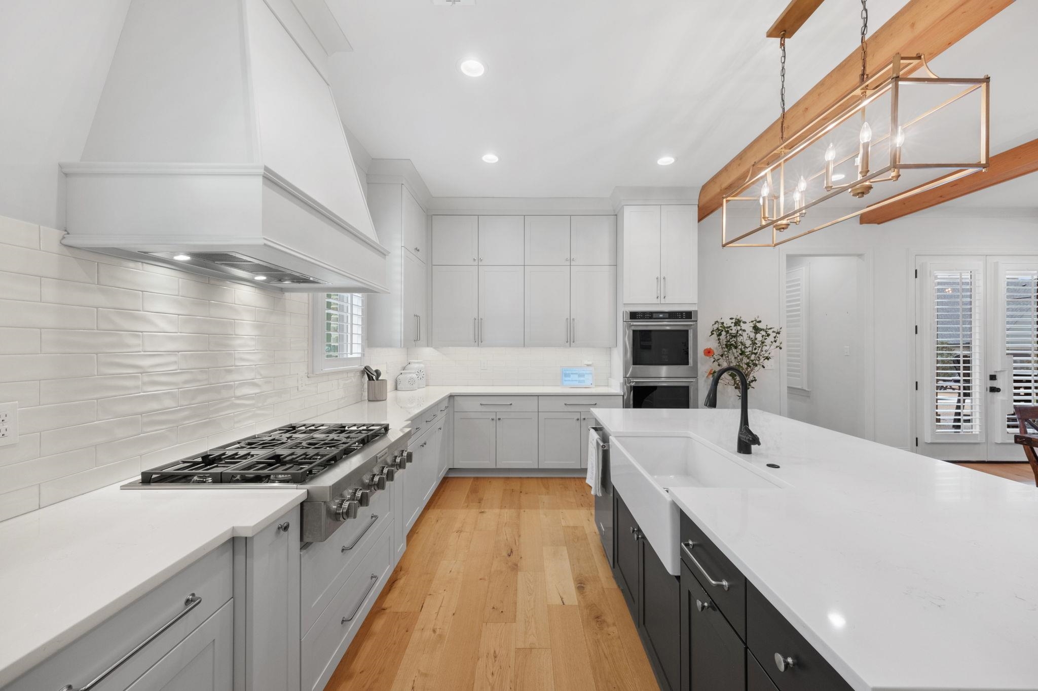 3361 Bailey Station Road Collierville, TN 38017 - Photo 13 of 40 a large kitchen with stainless steel appliances a sink a stove and cabinets