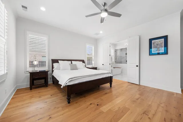 a spacious bedroom with a bed and a table in it