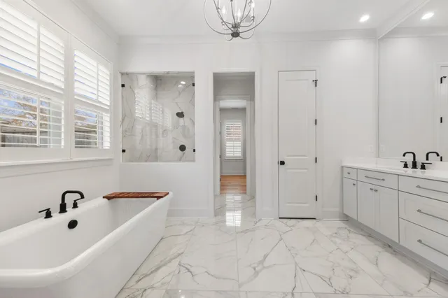 a bathroom with a tub sink and mirror