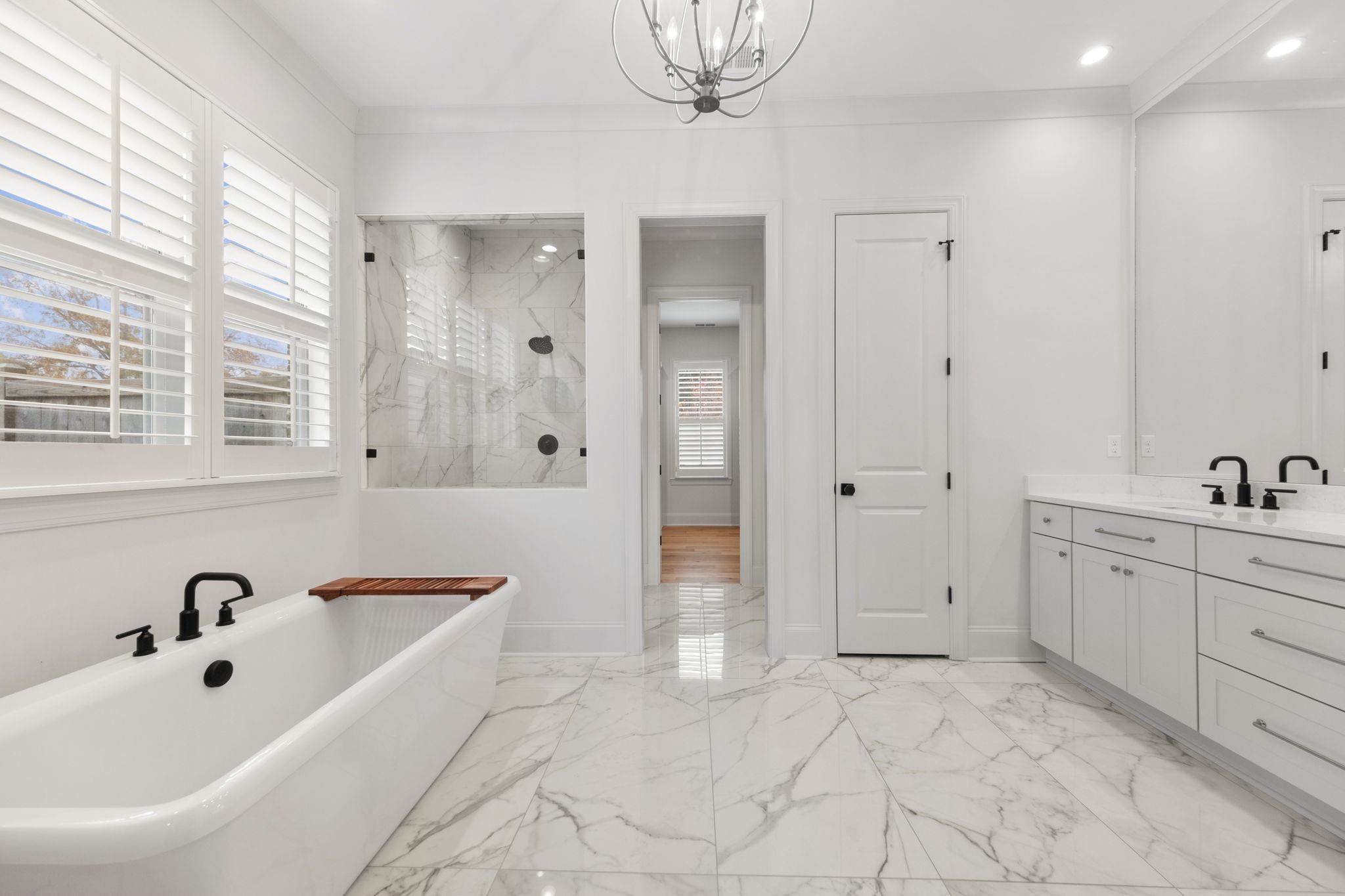3361 Bailey Station Road Collierville, TN 38017 - Photo 18 of 40 a bathroom with a tub sink and mirror