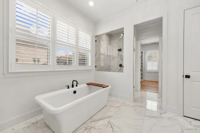 a white bath tub sitting next to a bathroom sink