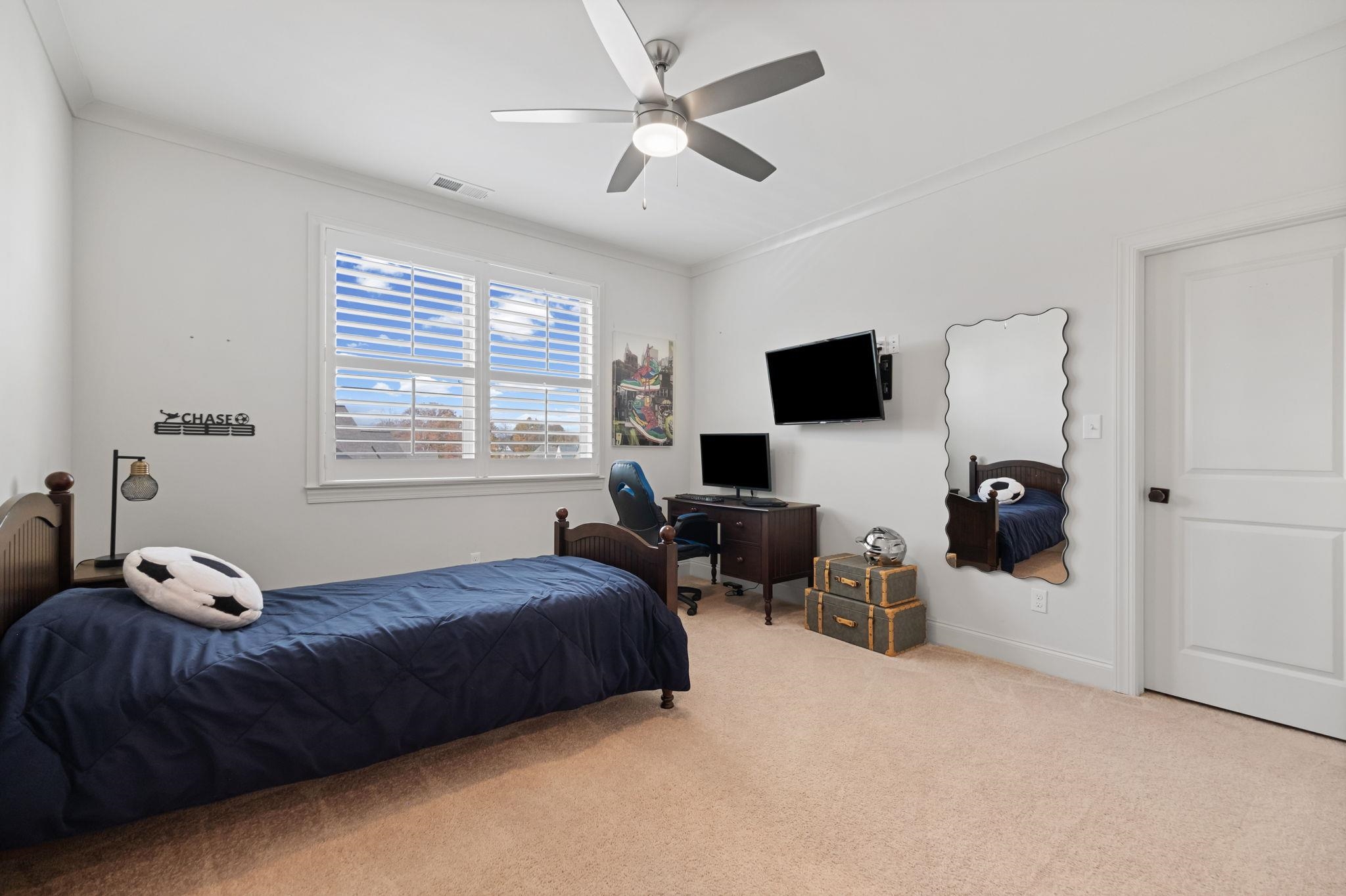 3361 Bailey Station Road Collierville, TN 38017 - Photo 25 of 40 a bedroom with a bed couches and a flat tv screen