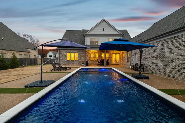 a view of swimming pool with an outdoor seating