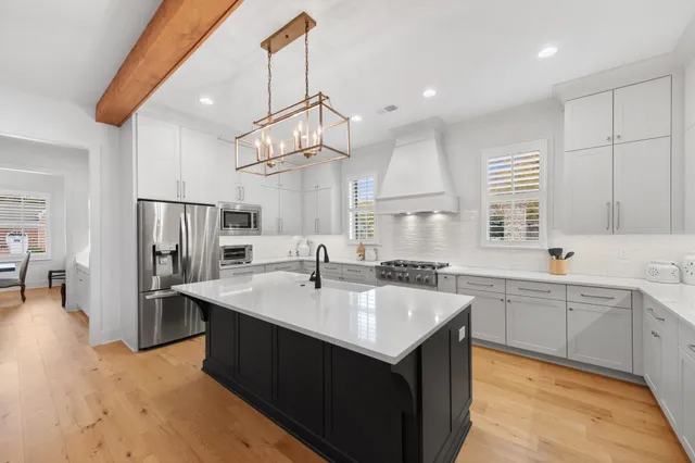 a large kitchen with kitchen island a sink stainless steel appliances and cabinets