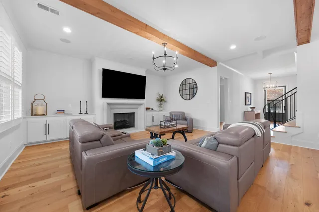 a living room with furniture a fireplace and a flat screen tv