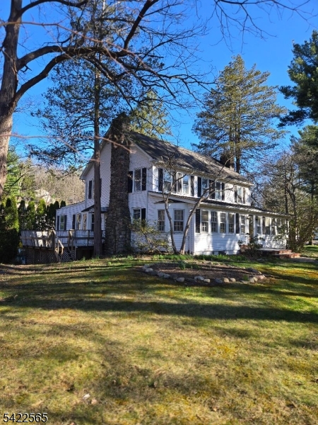 1 Pioneer Trail Oak Ridge, NJ 07438 - Photo 2 of 23 a front view of a house with a swimming pool