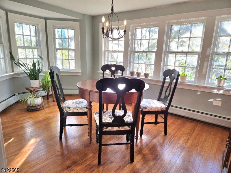 1 Pioneer Trail Oak Ridge, NJ 07438 - Photo 4 of 23 a view of a dining room with furniture window and wooden floor