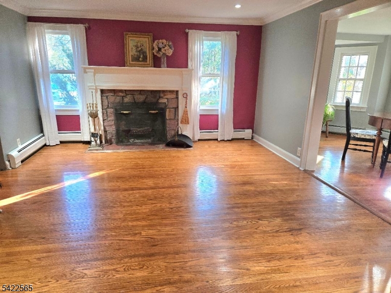 1 Pioneer Trail Oak Ridge, NJ 07438 - Photo 7 of 23 a view of empty room with wooden floor and fireplace