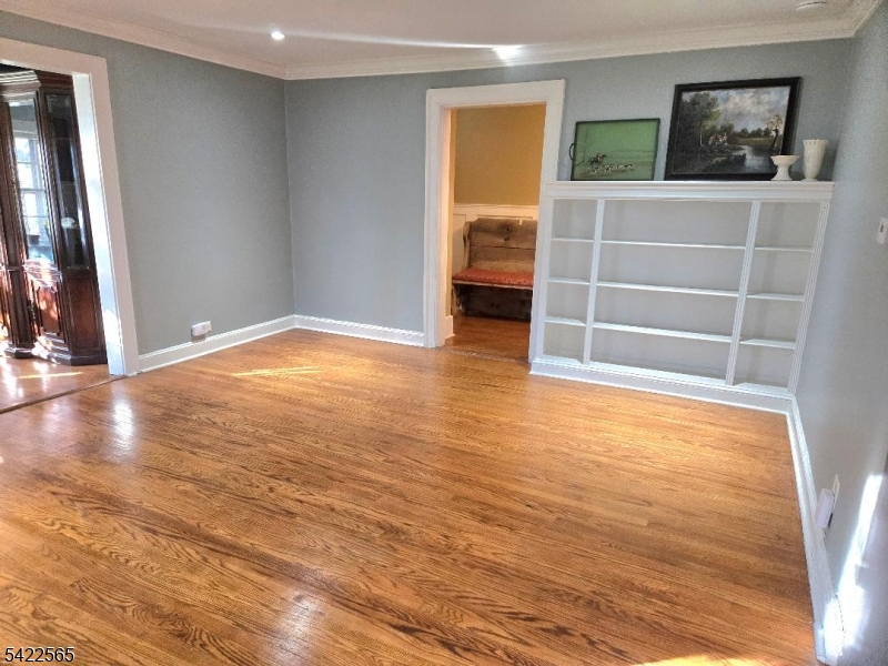 1 Pioneer Trail Oak Ridge, NJ 07438 - Photo 8 of 23 a view of an empty room with wooden floor and a window
