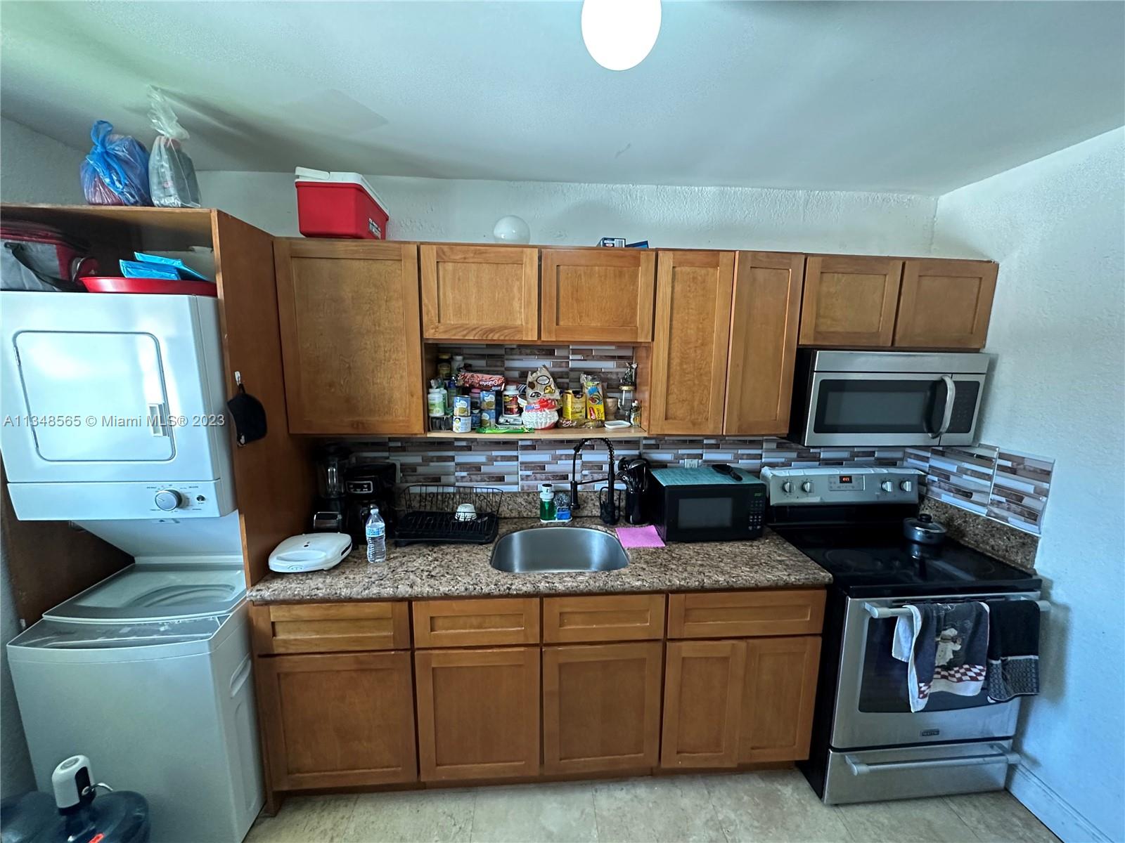 680 Southwest 10th Street, Unit 7 Miami, FL 33130 - Photo 13 of 34 a kitchen with a sink and a stove top oven