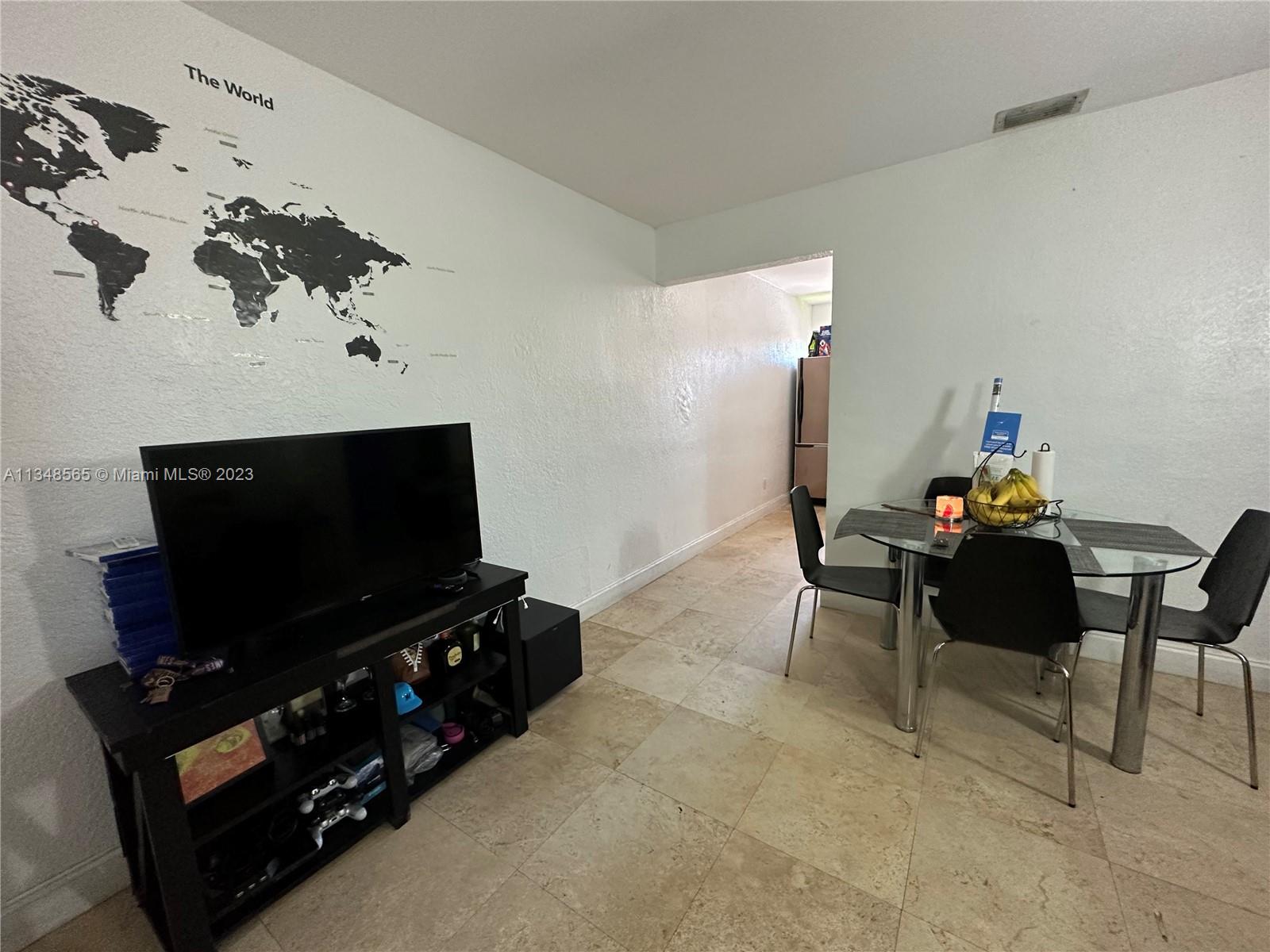 680 Southwest 10th Street, Unit 7 Miami, FL 33130 - Photo 15 of 34 a living room with furniture and a flat screen tv