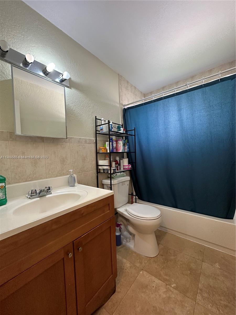 680 Southwest 10th Street, Unit 7 Miami, FL 33130 - Photo 20 of 34 a bathroom with a sink a toilet and a mirror
