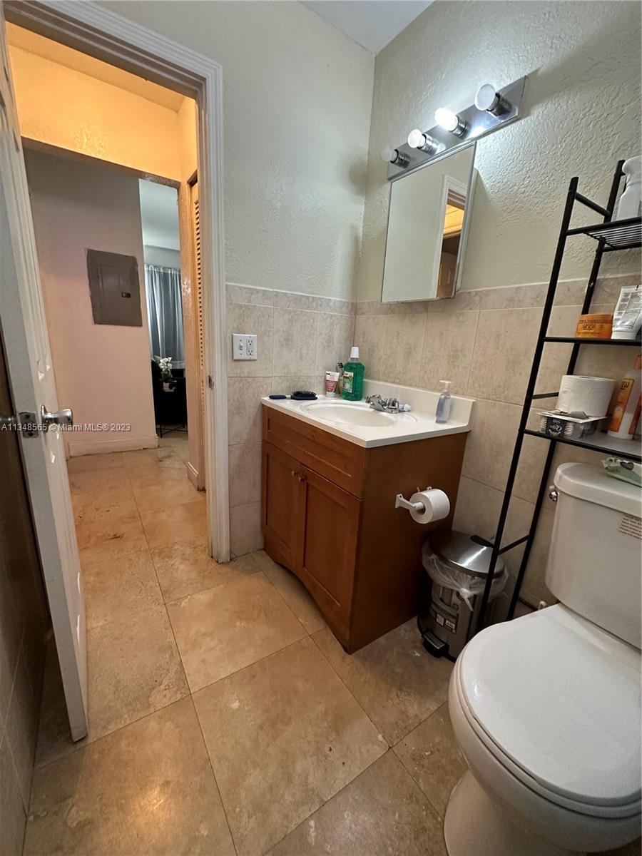 680 Southwest 10th Street, Unit 7 Miami, FL 33130 - Photo 21 of 34 a bathroom with a sink toilet and mirror