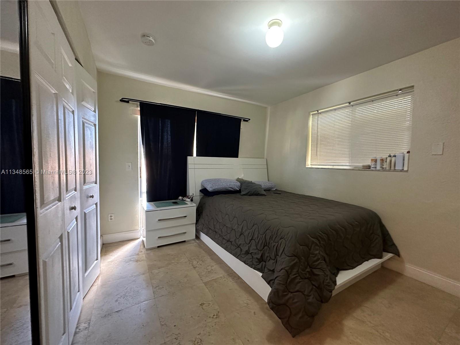 680 Southwest 10th Street, Unit 7 Miami, FL 33130 - Photo 22 of 34 a spacious bedroom with a bed and a walk in closet