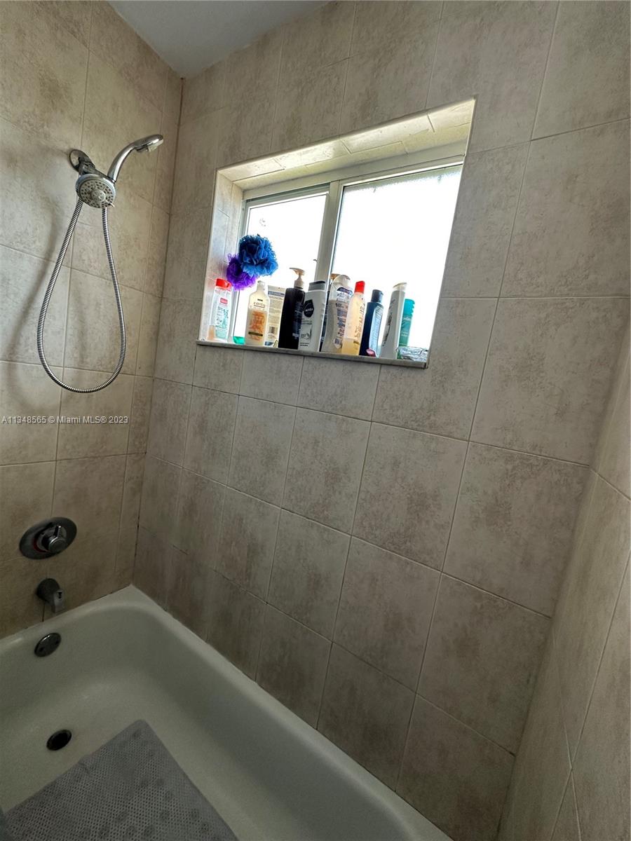 680 Southwest 10th Street, Unit 7 Miami, FL 33130 - Photo 24 of 34 a bathroom with a bathtub and a shower
