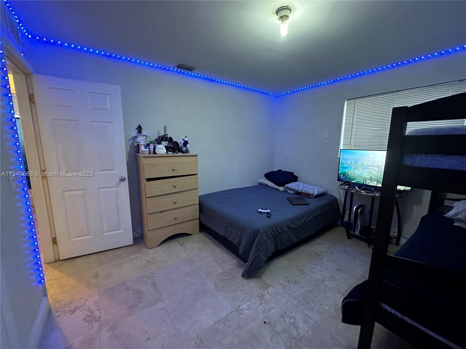680 Southwest 10th Street, Unit 7 Miami, FL 33130 - Photo 30 of 34 a bedroom with a bed and a tv